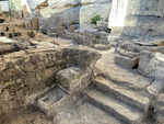 A staircase ascending from Hall H2 into courtyard H6, which has a cistern at its center, looking southwest.